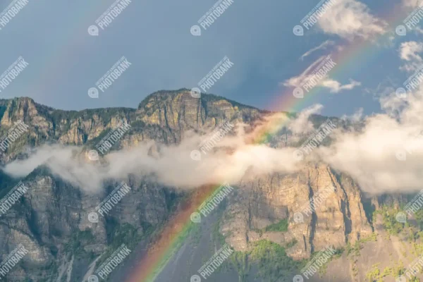 A rainbow by the mountains