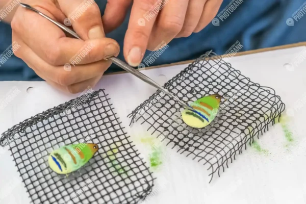 Close up of artist working on copper art