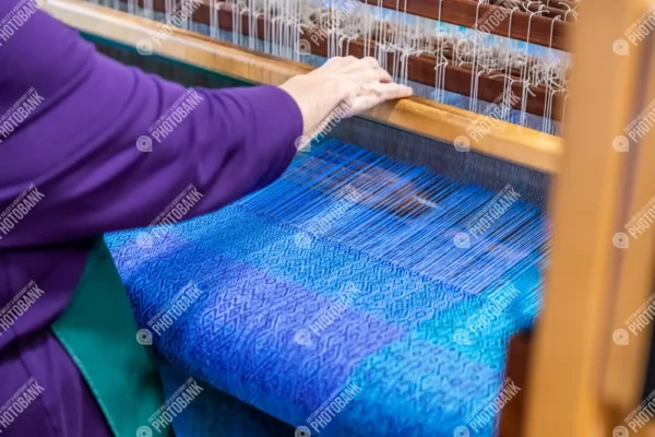 Close up of hands at loom