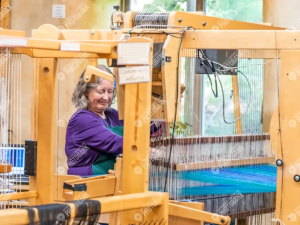 Woman smiling at loom